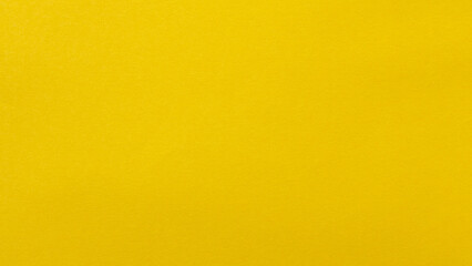 Fototapeta premium Bright yellow paper background surface with smooth uniform texture for copy space