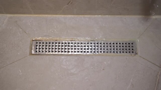Cleaning a shower drain in a bathroom at home