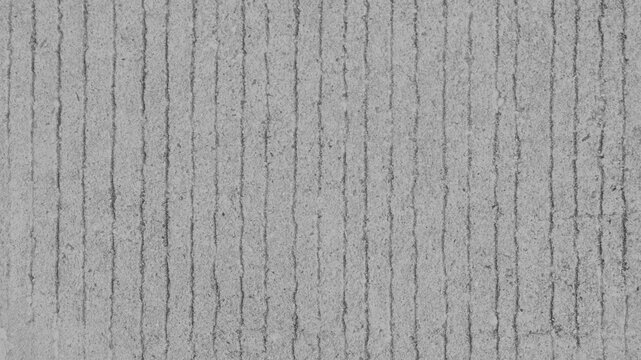 Gray concrete desktop wallpaper with vertical grooves and a rough texture
