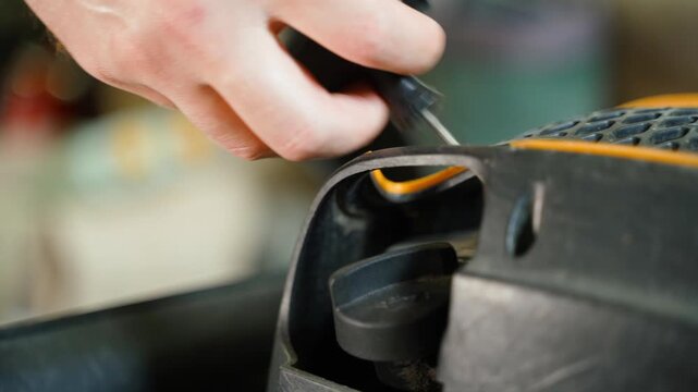 Starting lawn mower process. Hand pulling manual starter cord close-up