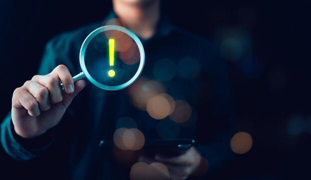 Cybersecurity analyst investigates digital risk alerts using magnifying glass inspection, threat detection system, data breach warning signal, online security monitoring, fraud prevention analysis