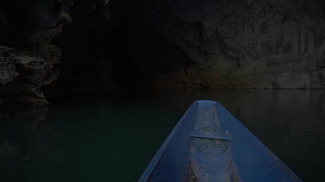 POV on a tour boat as it enters a cave and the sunlight disappears