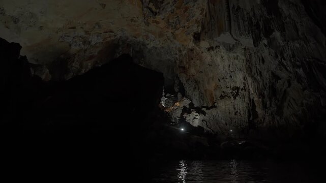 Smooth reveal of a large cave chamber inside Kong Lor cave as seen on the underground river that flows through the cave.