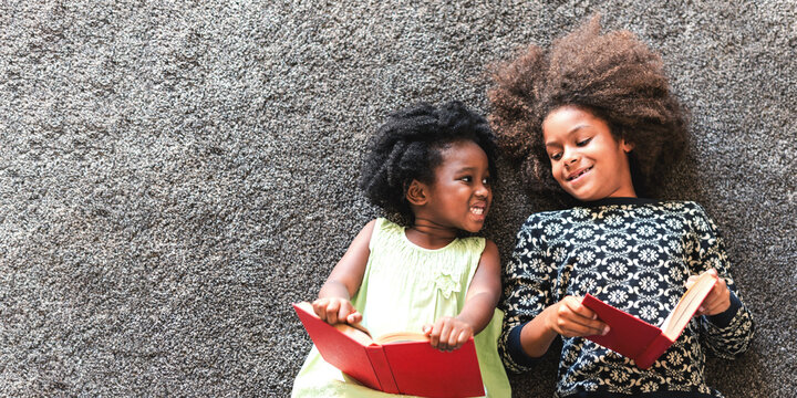 Joyful siblings reading together photo