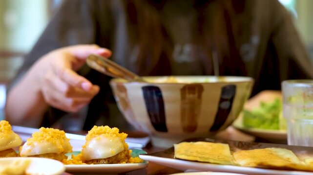 Asian Woman Using Smartphone and Eating Vietnamese Cuisine in Restaurant