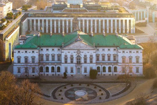 Aerial view of the historic Krasinski Palace with its green roof and baroque facade during golden hour in Warsaw, Masovian Voivodeship, Poland.