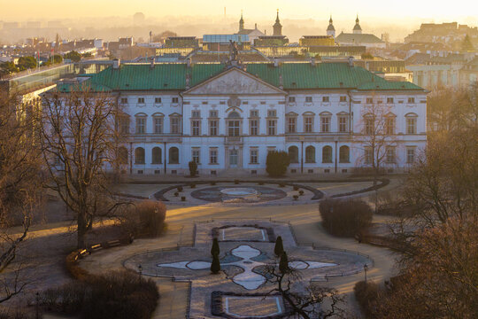 Aerial view of the Krasinski Palace featuring its green roof and formal gardens during golden hour in Warsaw, Masovian Voivodeship, Poland.