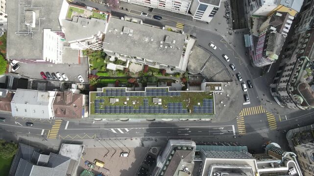 Aerial Top View of Urban Building with Green Roof and Solar Panels in Swiss City