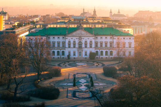 Aerial view of the historic Krasinski Palace with its green roof and baroque facade overlooking a formal garden during golden hour in Warsaw, Masovian Voivodeship, Poland.