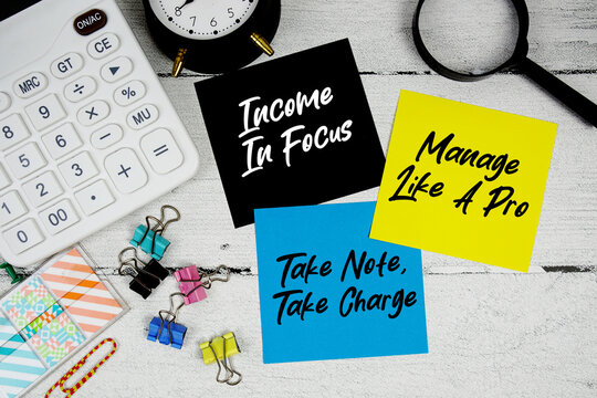 Income In Focus, Manage Like A Pro, Take Note Take Charge text written on paper note with calculator and magnifying glass on wooden background