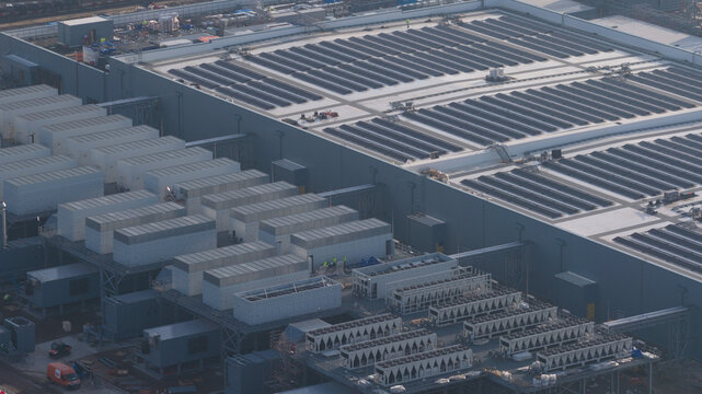 Aerial view of Datacenter Westpoort showing rows of cooling units and industrial infrastructure in Groningen, Groningen, Netherlands.