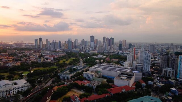 Aerial cityscape view during twilight sunset overlooking clusters of skyscraper buildings in Manila, Philippines