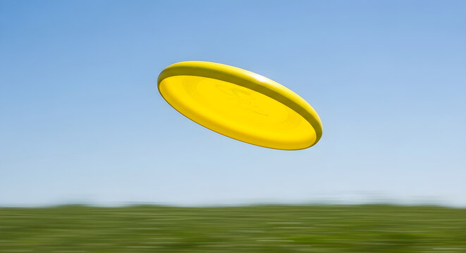 A bright yellow frisbee flies through a clear blue sky over a blurred green field, capturing a moment of outdoor recreation and fun