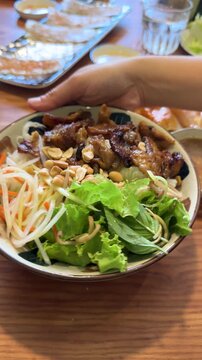 Vietnamese Bun Thit Nuong Grilled Pork Rice Noodle Bowl Rotating on Table