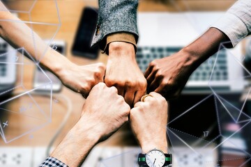 Obraz premium Diverse colleages giving a fist bump