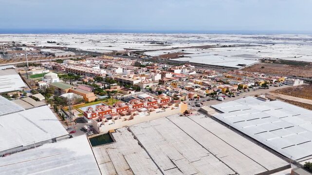 city terra forming agriculture industry greenhouse invernaderos earth field plastic sea border town frontier industrial roof architecture housing building drone - Andalusia, Spain - 2025
