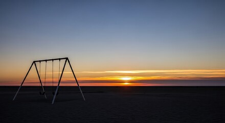 Fototapeta premium Sunset over empty swing set outdoors.