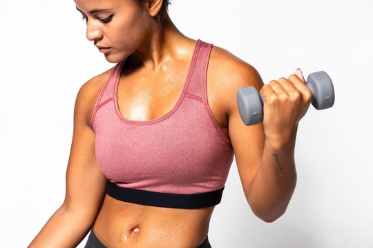 Focused woman lifting dumbbell photo