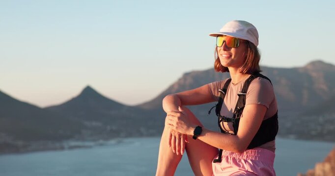Woman, hiking and thinking with sunglasses on mountain with ocean view, space and relax on summit. Girl, outdoor and break on peak, rocks and perspective with trekking, adventure and smile in summer
