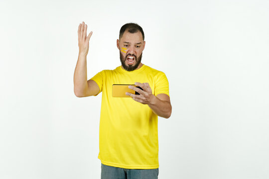 Soccer fan watching game on smartphone expressing frustration