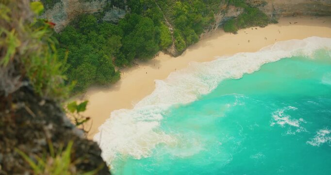 Stunning aerial perspective of turquoise ocean water meeting white sand tropical beach