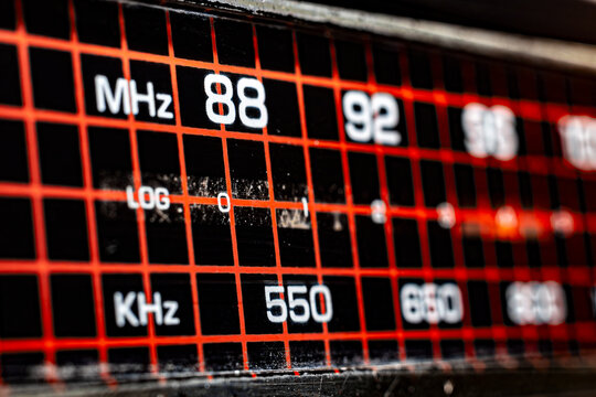 Extreme Macro of Vintage Radio Tuning Scale with 88 MHz and 550 KHz Frequency Markers, Retro Electronic Hardware Background with Red Glowing Grid for Audio Production and Media Design