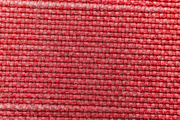 Fototapeta premium Macro photography of vibrant red woven fabric with detailed interlaced threads and symmetrical textile pattern for fashion industry background or upholstery material reference