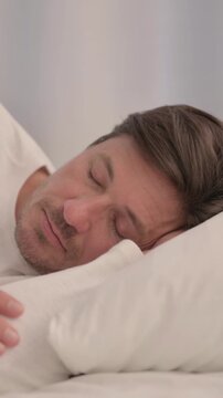 Adult Man Sleeping in Bed on Side, vertical