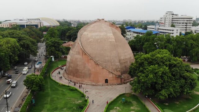Aerial drone view of Golghar in Patna, Bihar, showcasing the iconic historic granary surrounded by urban landscape, greenery, and the scenic skyline of the city.
