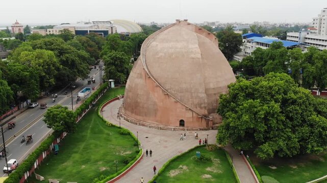 Aerial drone view of Golghar in Patna, Bihar, showcasing the iconic historic granary surrounded by urban landscape, greenery, and the scenic skyline of the city.
