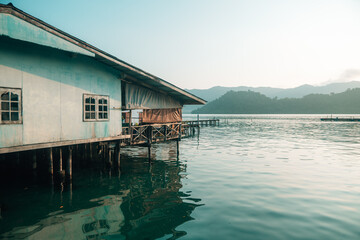 Authentic Overwater Wooden House and Floating Fishing Raft in Tropical Bay © artrachen