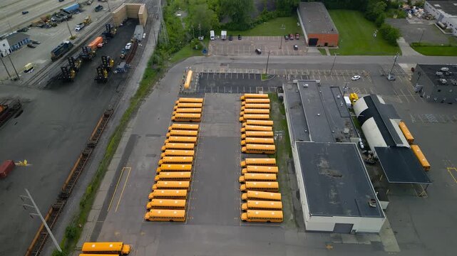 Aerial view of many yellow school buses parked in a lot