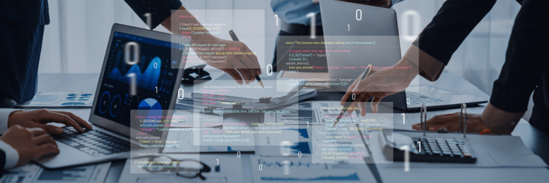 Hands engaged in a collaborative technology meeting, with laptops and digital data analysis displayed, showcasing teamwork and modern business strategies in a contemporary office. Trope