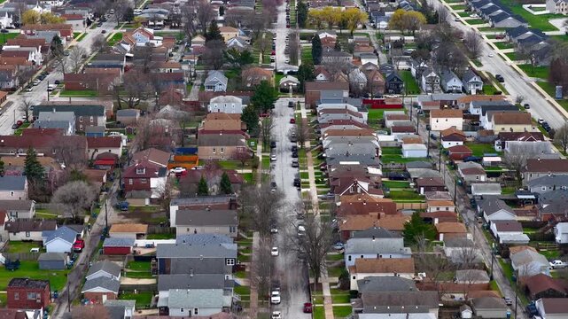Aerial drone flying over american suburban neighborhood street near Chicago.