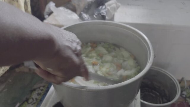 Stirring Vegetable Soup with Potato Carrot and Cabbage in Boiling Pot