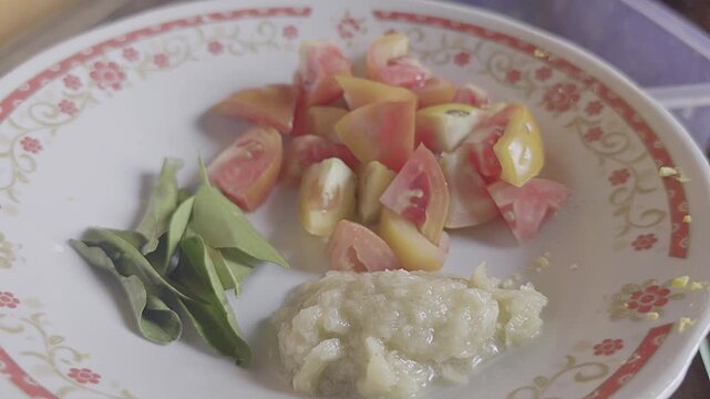Tomato Kaffir Lime Leaves and Mashed Garlic on Plate in Rustic Kitchen