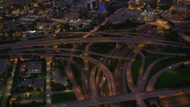 Cinematic aerial daytime footage of the massive multi-level High Five Interchange and heavy highway traffic in Dallas, Texas.