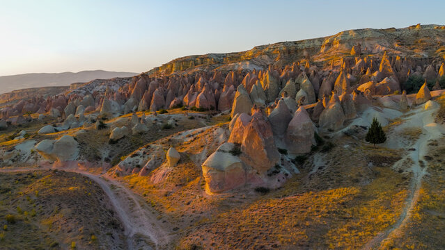 Goreme, Nevsehir, Turkey. Evening aerial perspective of Devrent Valley highlighting geological diversity and mineral color variations at dusk.. Aerial View