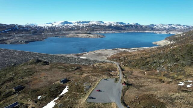Sysendammen reservoir with reduced water level on Hardangervidda Norway showing regulated storage