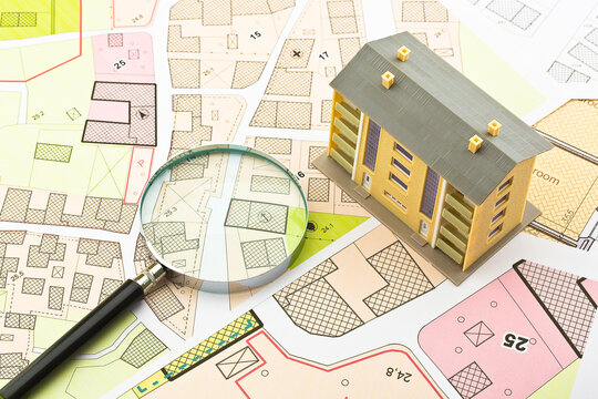 Imaginary cadastral map and general urban plan with cadastral parcels, urban destinations, vacant land plots and condominium residential building