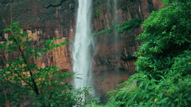 4K Slow motion shot of Kaataldhar waterfall flowing during the monsoon season after rainfall as seen near Lonavala in Maharashtra, India. Natural scenic background with copy space. Natural view.