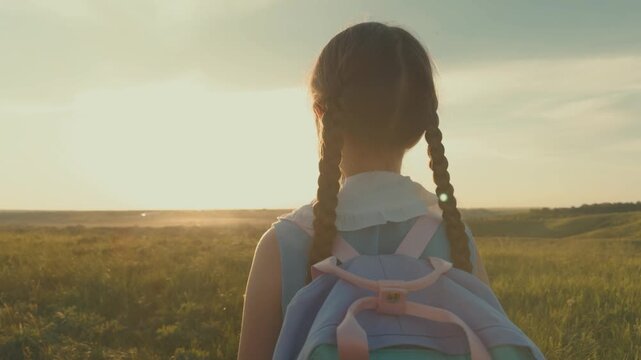 small child backpack, girl daughter sunset, view from back, child looking sunset, first grader praying before first lesson, lesson school, kid child girl looking sunset cinematic, children dream