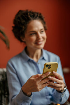Woman smiling and texting on smartphone for communication