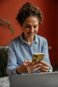 Woman using smartphone for communication and browsing