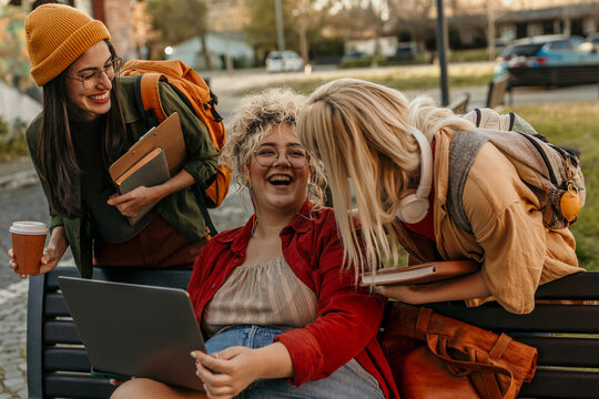 Students collaborating on campus, sharing thoughts and laughing
