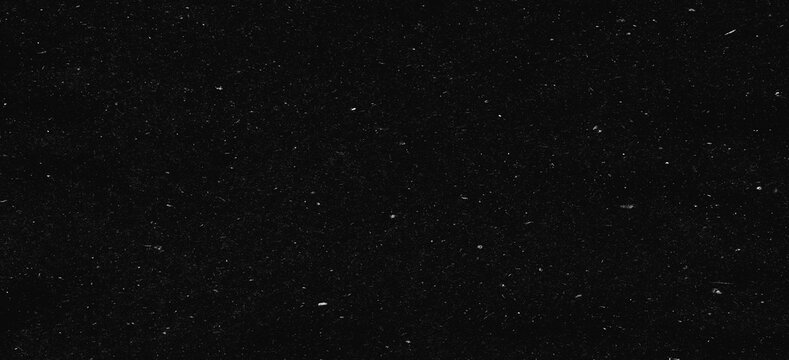 white dust and scratches on a black background. The texture of dirt on the glass