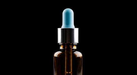 Naklejka premium Amber glass dropper bottle with blue tip, metallic neck, against stark black background