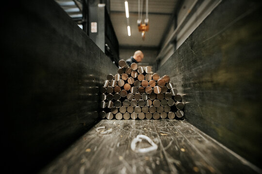 Steel round bars stacked in metal fabrication warehouse, raw material