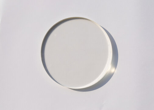 Top View of Round Transparent Glass Petri Dish or Coaster on White Background