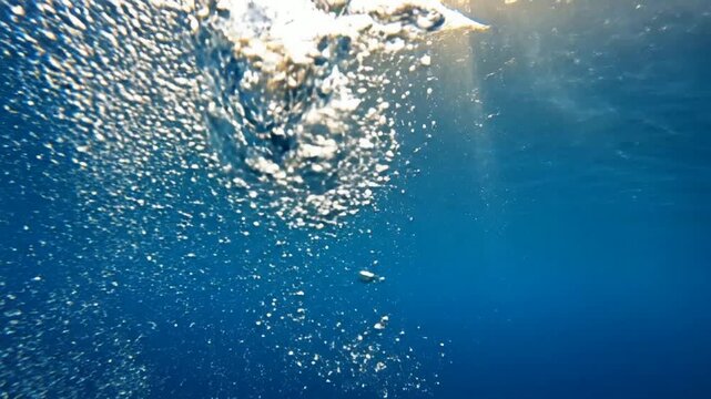 Bubbles Rising Through Deep Blue Ocean Water - Sunlight Rays Sparkling Underwater